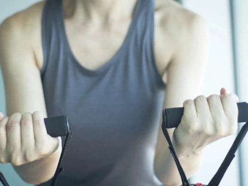 Woman using resistance bands during corrective exercise for posture and joint mobility