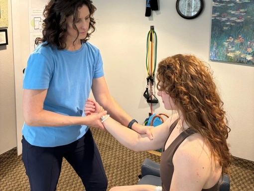 Dr. Fawn Ray performing myofascial release therapy to relieve arm tension and restore function