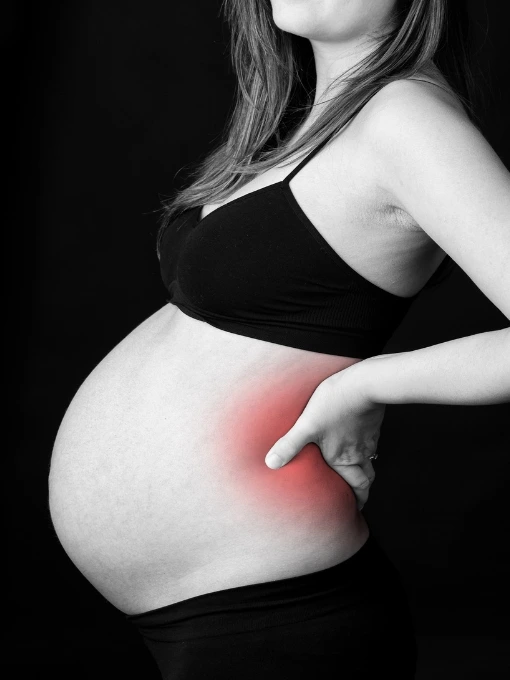 Pregnant woman with back pain receiving prenatal chiropractic care using the Webster Technique